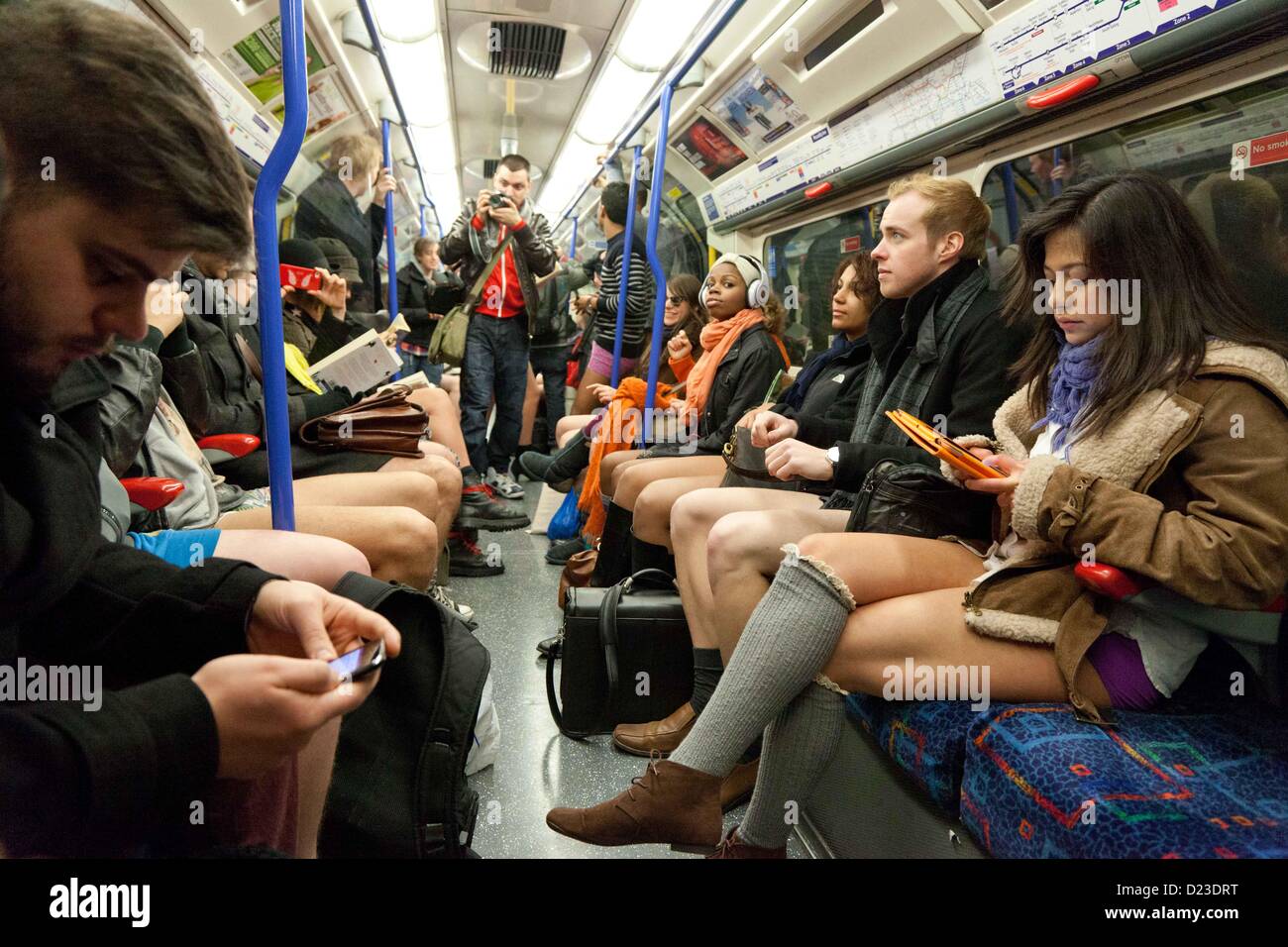 London, UK. 13th January 2013 Participants of the annual no trousers day on  the tube sit on a tube carriage while just in their underwear Stock Photo -  Alamy