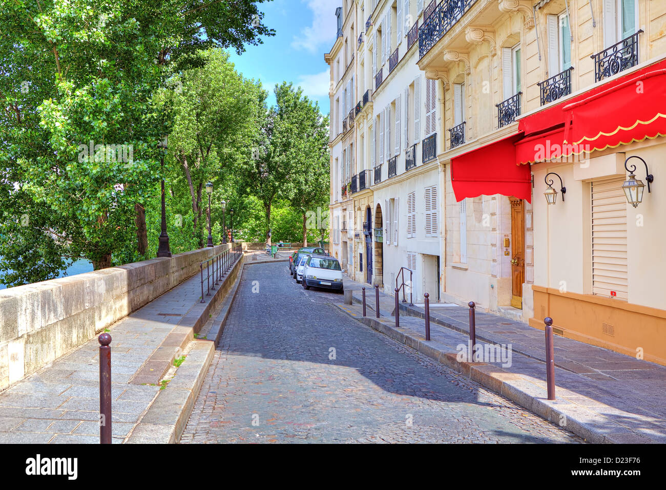Narrow cobbled street in front of typical parisian building in Paris, France. Stock Photo