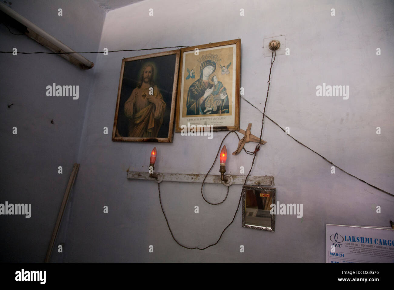 wall in shop with pictures of Jesus hanging ont he wall, tamil nadu, india Stock Photo