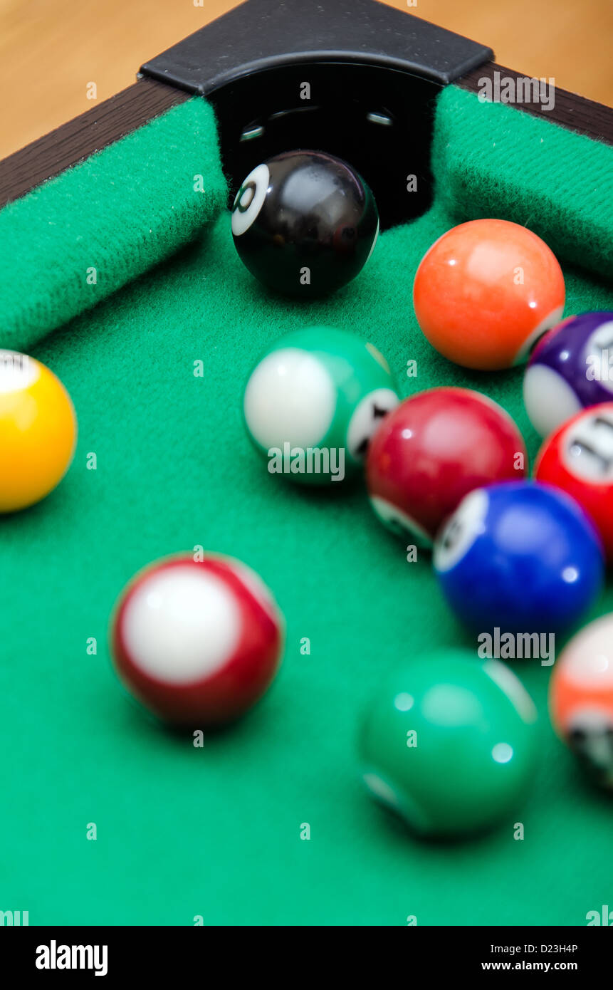 Pool game balls on green felt table Stock Photo Alamy