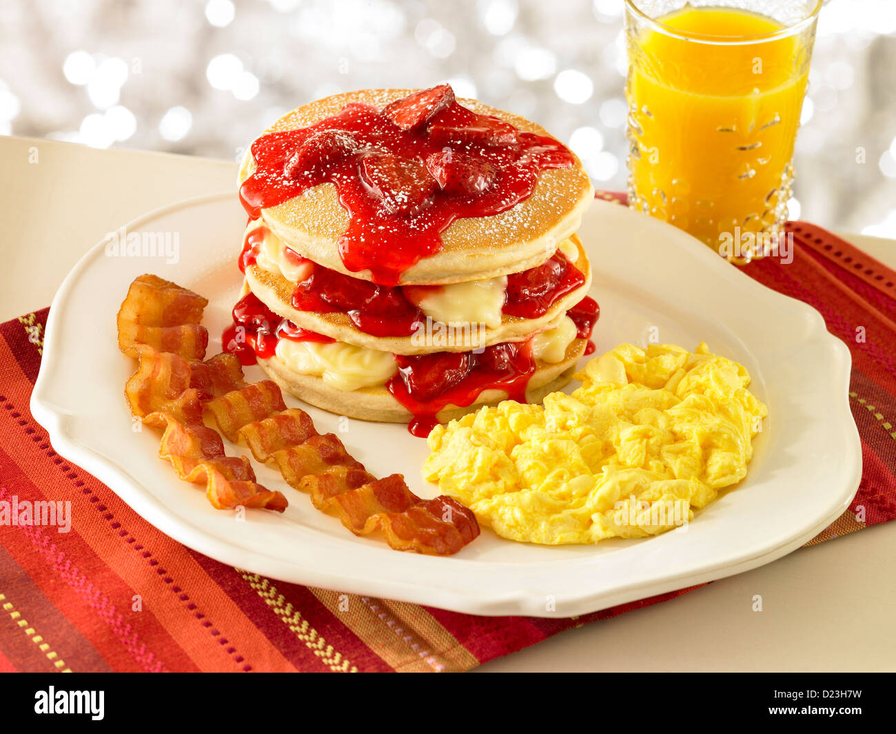 Strawberry stuffed pancake stack with orange juice Stock Photo