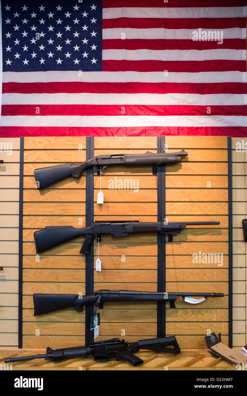 Shotguns and Assault rifles on display at a gun store.  Stock Photo