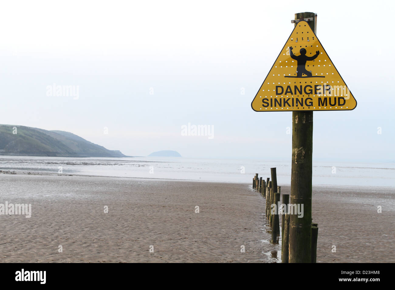 Danger sinking mud warning sign on the beach at Uphill, near Weston super Mare, January 2013 Stock Photo