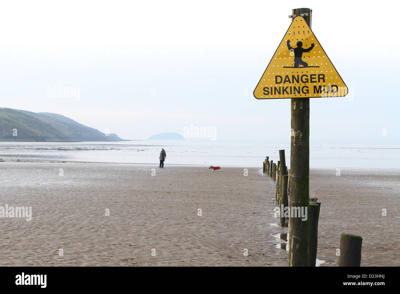 Danger sinking mud warning sign on the beach at Uphill, near Weston super Mare, January 2013 Stock Photo