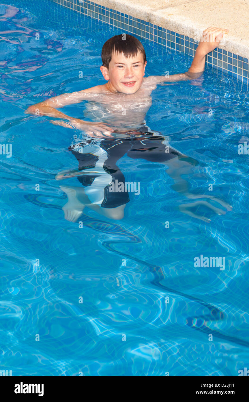 A 12 year old boy swimming in a swimming pool Stock Photo Alamy