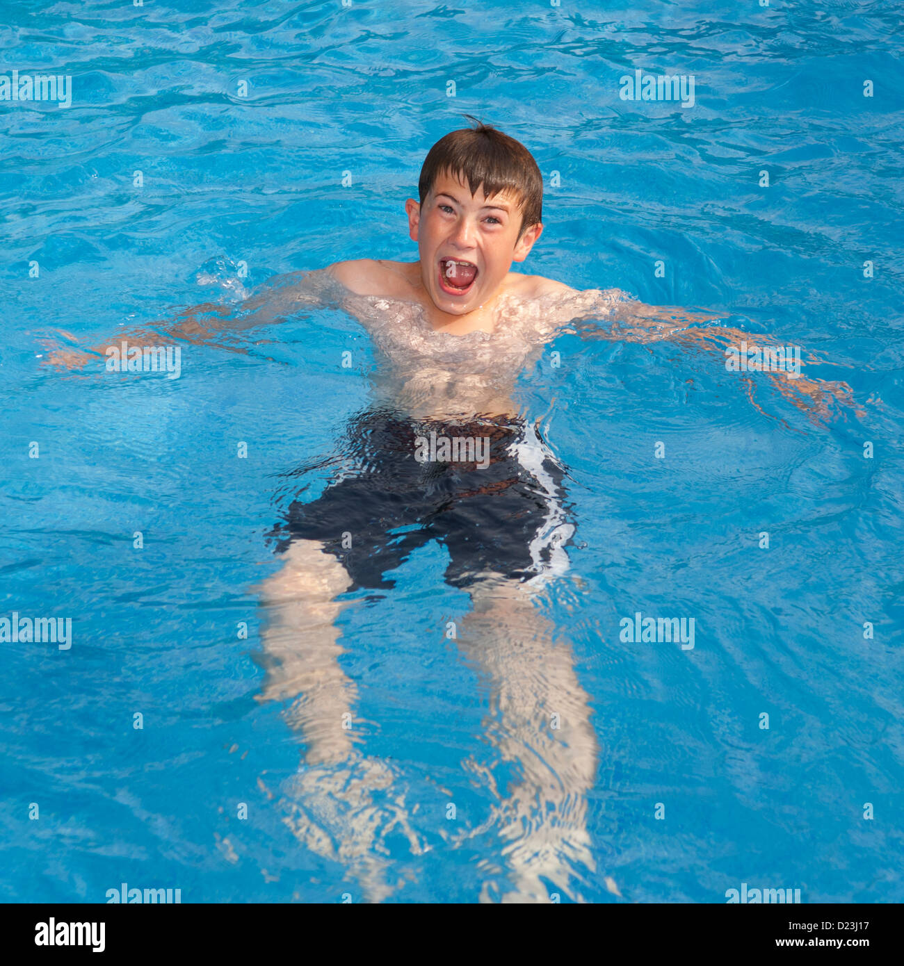 A 12 year old boy swimming in a swimming pool Stock Photo Alamy