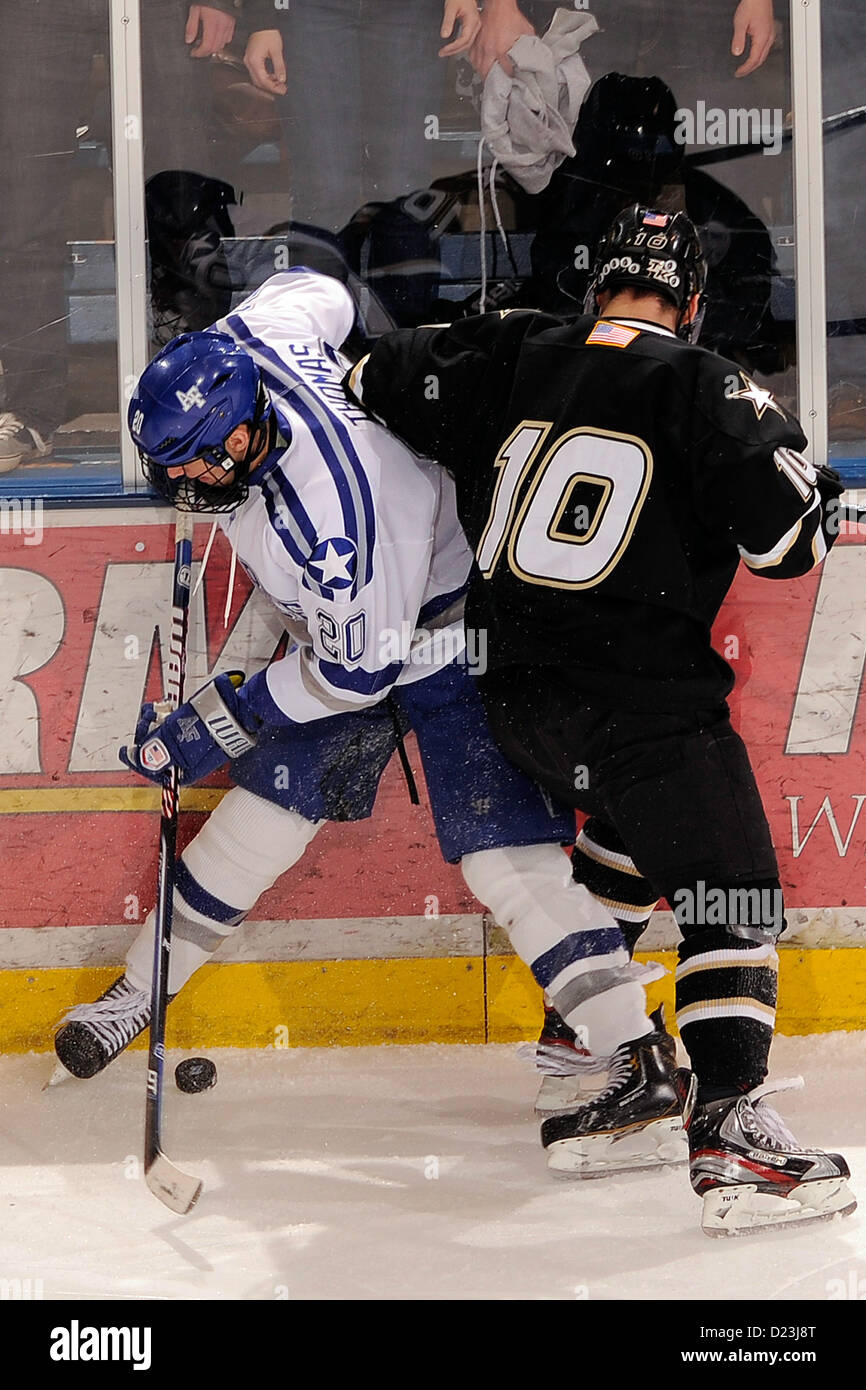 Junior Tony Thomas fights for control of the puck with Army sophomore Zak Azremba as Air Force met the Army Black Knights at the U.S. Air Force Academy's Cadet Ice Arena Jan 12, 2013 in Colorado Springs, Colo.   The Falcons and the Black Knights skated to a 3-3 overtime time.  Air Force defeated Army the night before, 4-1. (Air Force photo/Mike Kaplan) Stock Photo