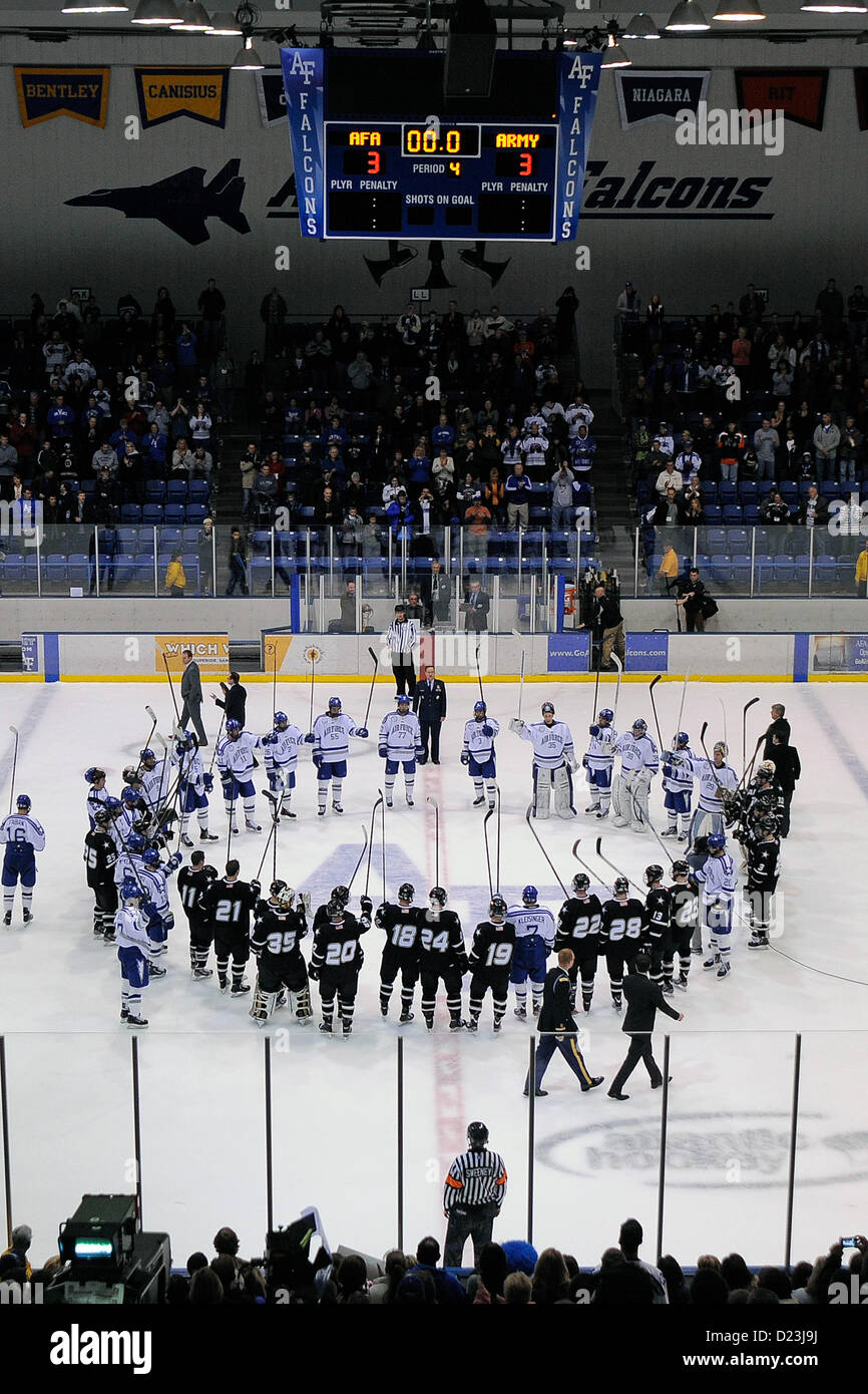 Air Force and Army do a stick salute on center ice after skating to a 3-3 tie at the U.S. Air Force Academy's Cadet Ice Arena Jan 12, 2013 in Colorado Springs, Colo.   Air Force defeated Army the night before, 4-1. (Air Force photo/Mike Kaplan) Stock Photo
