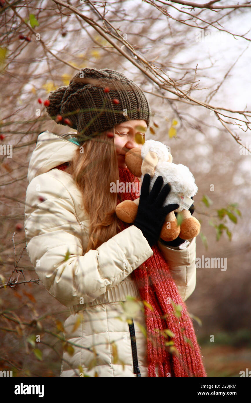 girl playing with doll in forest while smiling Stock Photo - Alamy