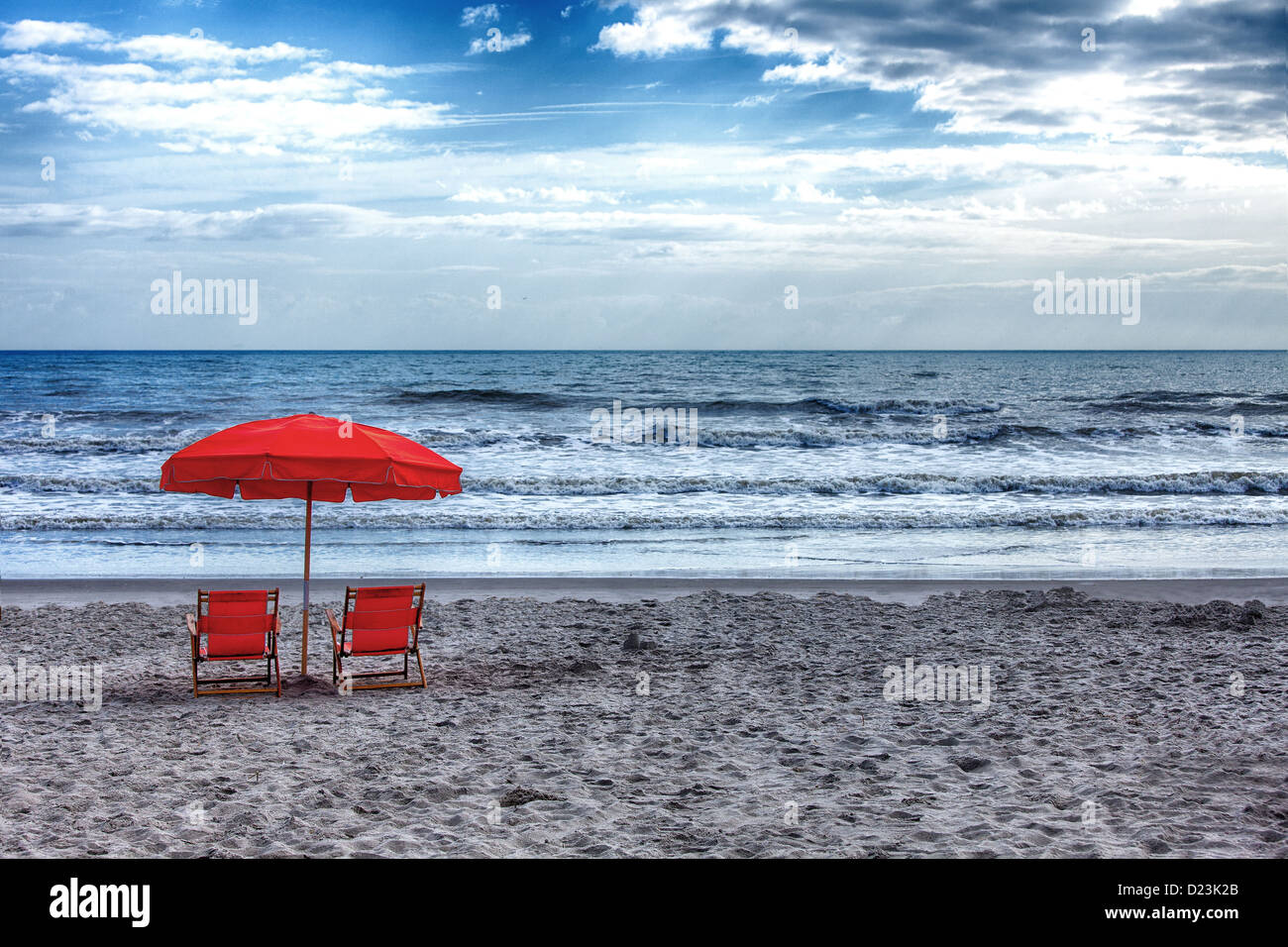 A red and orange umbrella on a Florida beach. Stock Photo