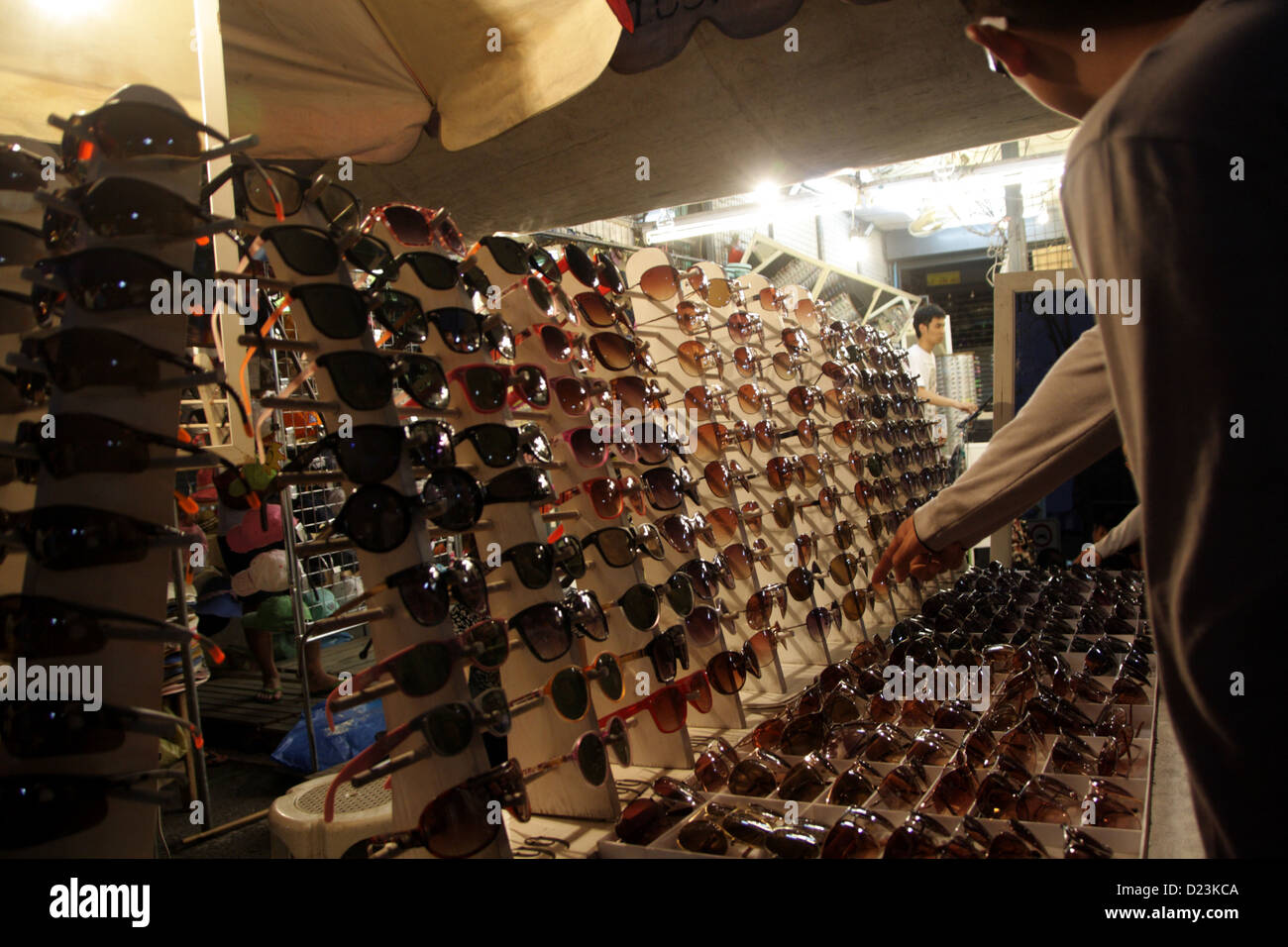 Customer choosing sunglass at a shop in Chatuchak Weekend Market