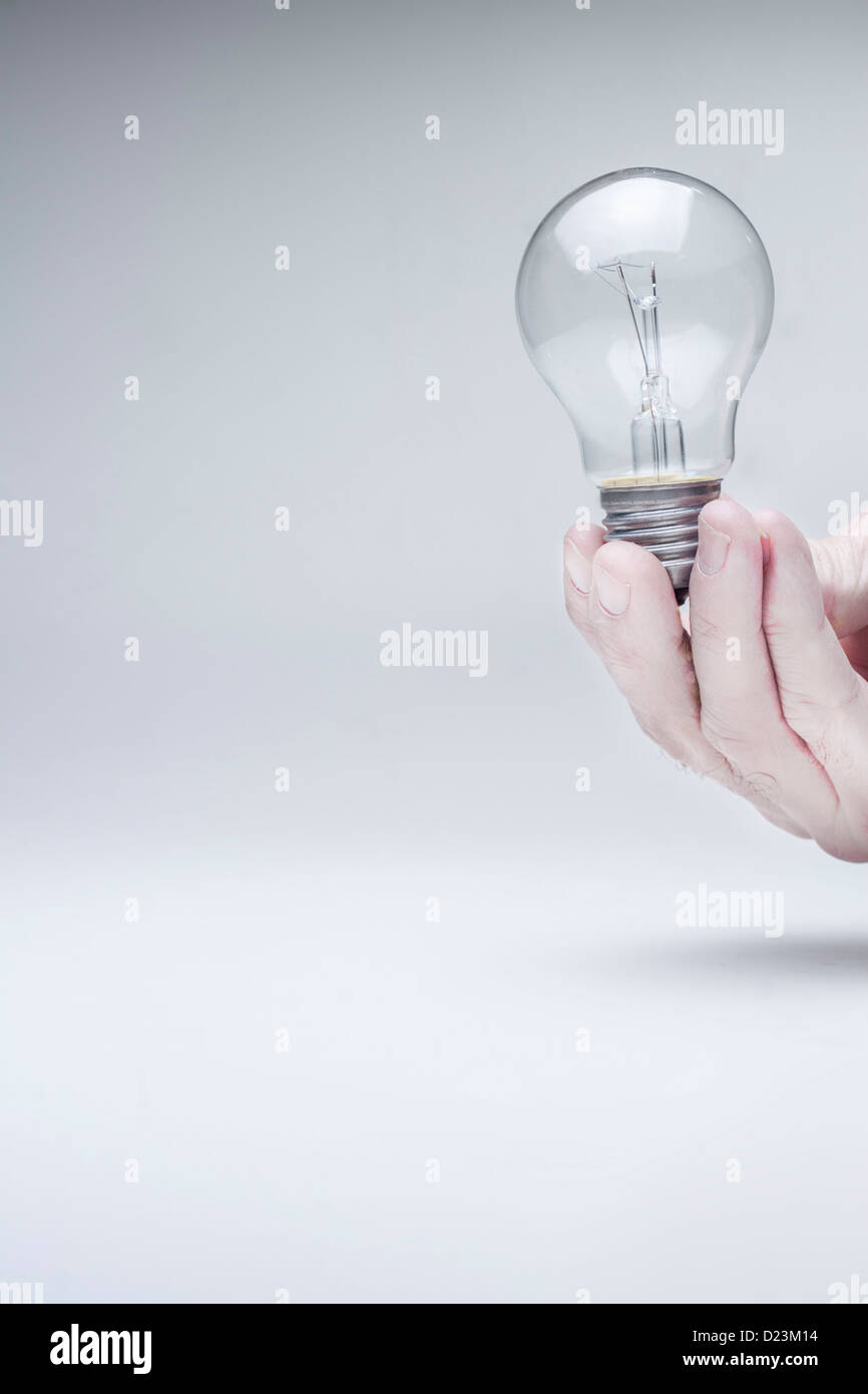 light bulb hold  by hand Stock Photo