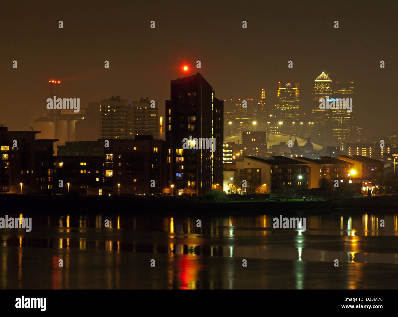 Night view of the Shard, Canary Wharf and the 02 Arena from Thamesmead SE London showing riverside apartments and River Thames. Stock Photo