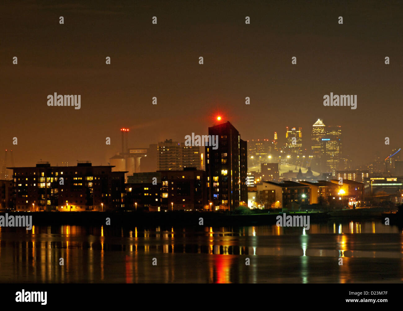 Night view of the Shard, Canary Wharf and the 02 Arena from Thamesmead SE London showing riverside apartments and River Thames. Stock Photo