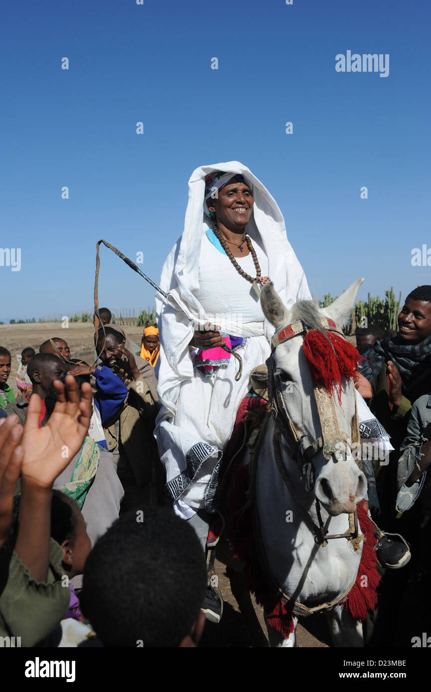 Mangudo, Ethiopia, woman rides a mule to school inauguration Stock