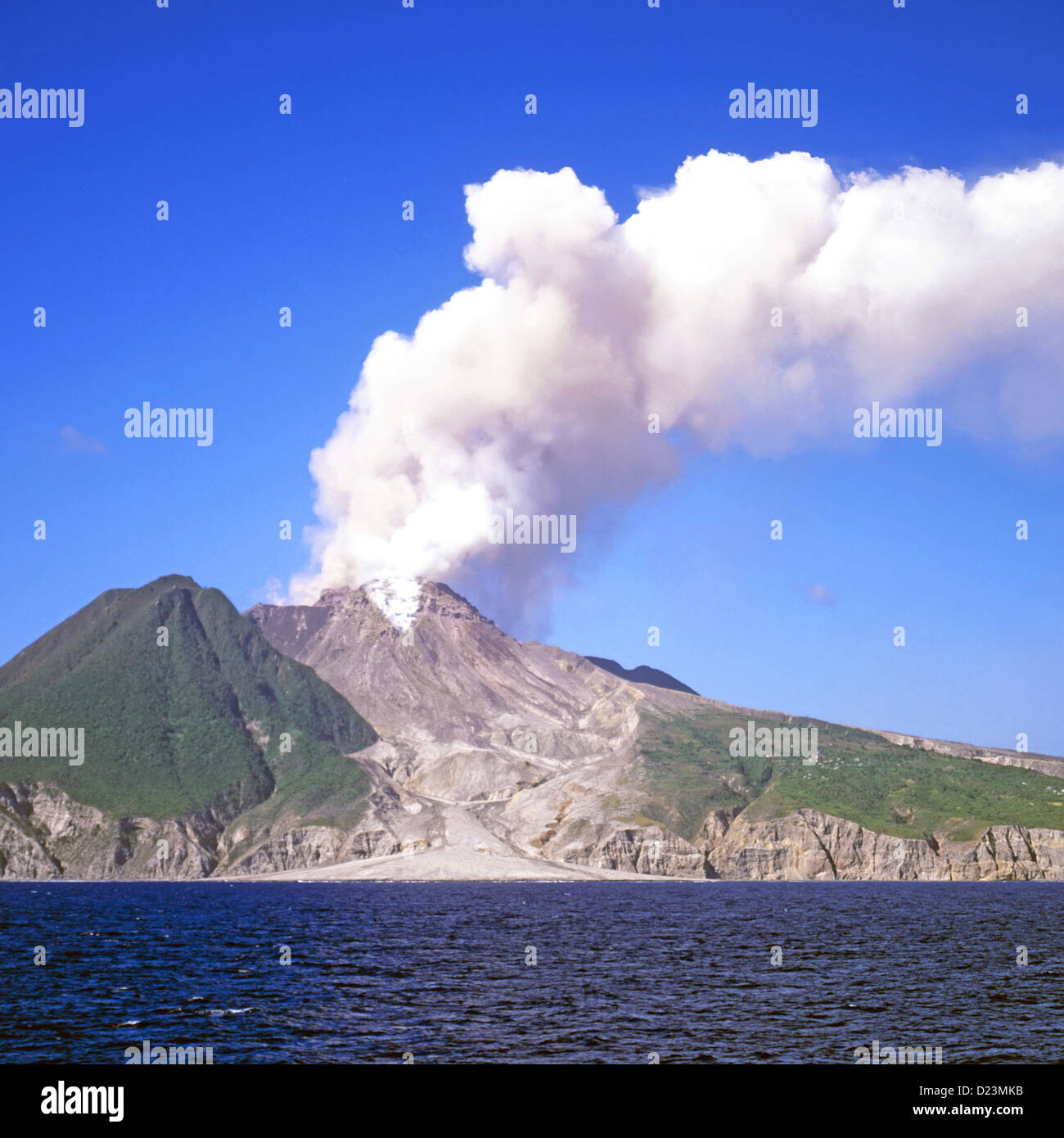 Caribbean Montserrat island devastation in Soufriere Hills volcano eruption smoke & steam aftermath solidified lava to sea in landscape devastation Stock Photo