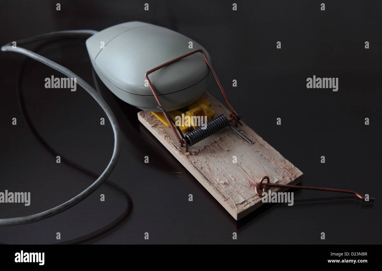 a vintage gray computer mouse trapped in a mouse trap. Low key Stock