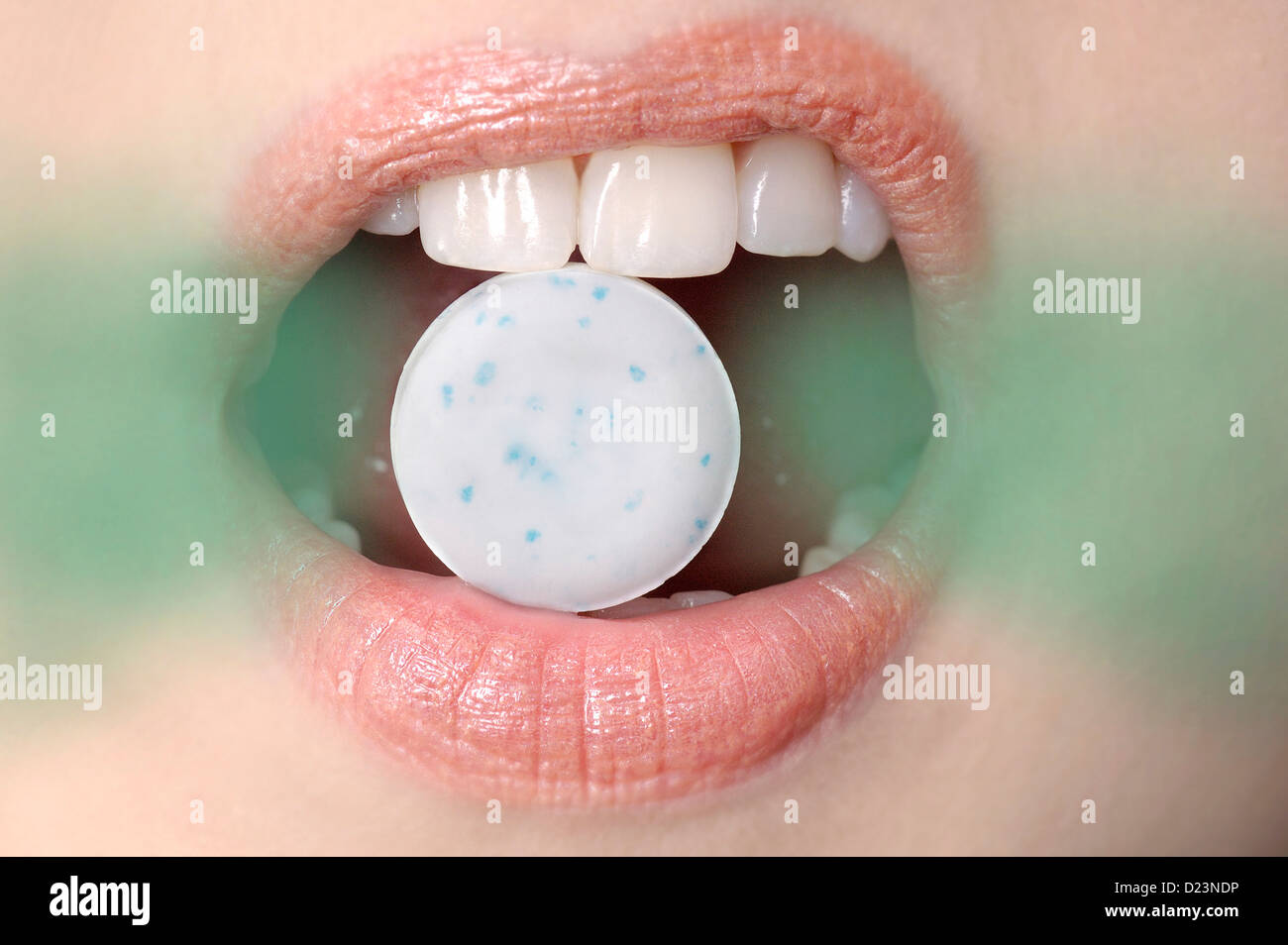 Female mouth with breath mint and bad breath odor coming out. Stock Photo