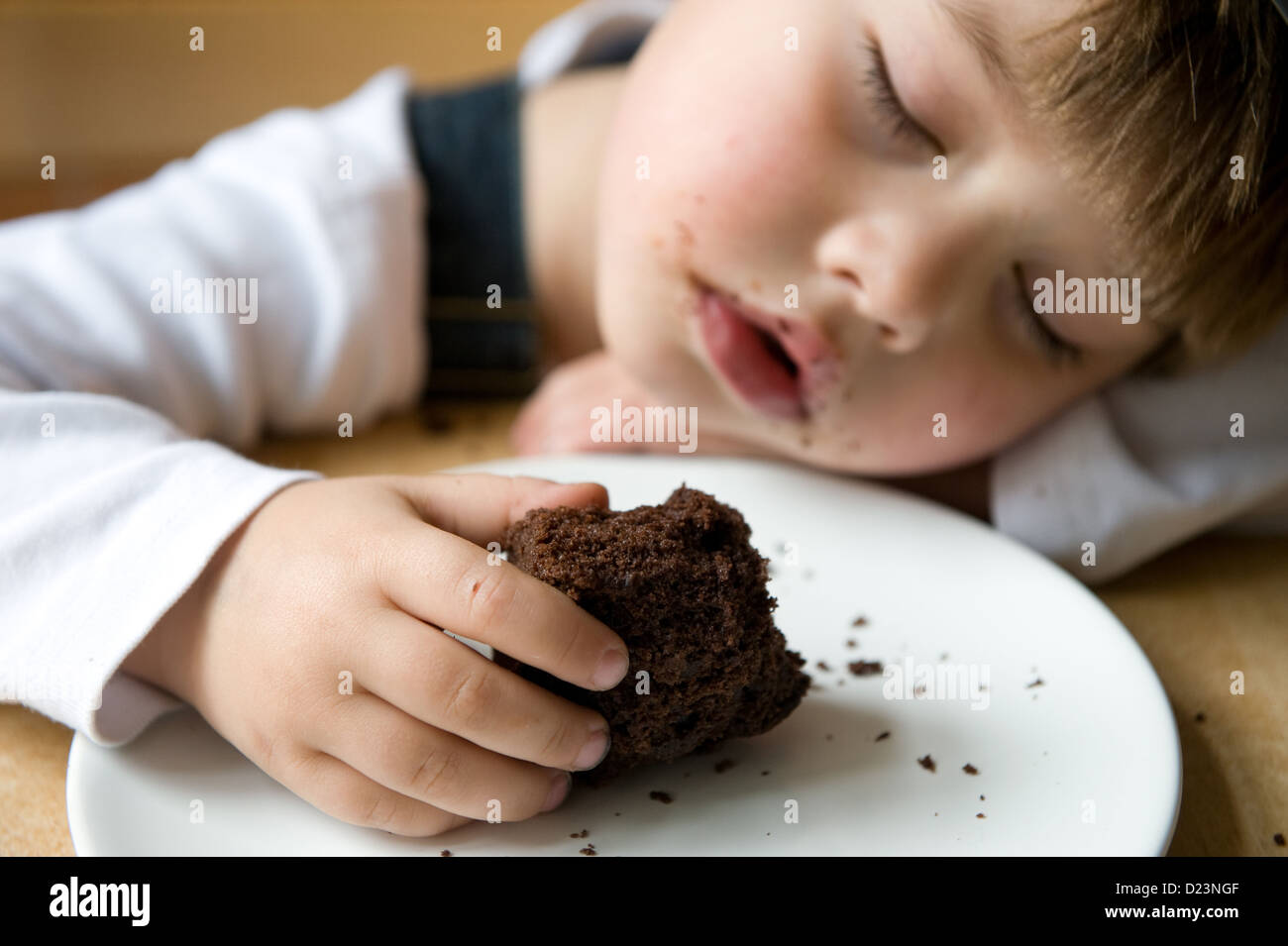 Berlin, Germany, the boy is asleep while eating cake Stock Photo