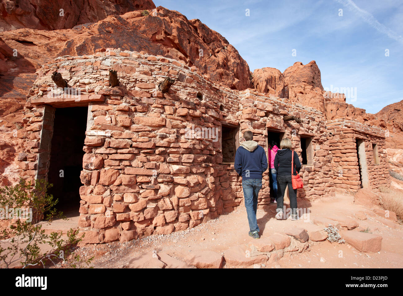 Tourists Visiting Three Historic Stone Cabins Built By The