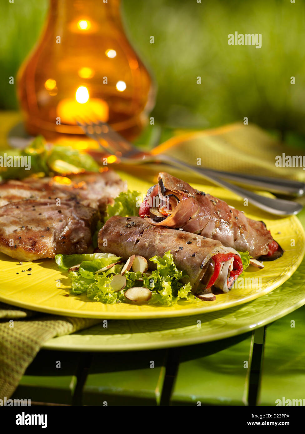 Eggplant, prosciutto and roasted red pepper involtini in an outdoor setting Stock Photo