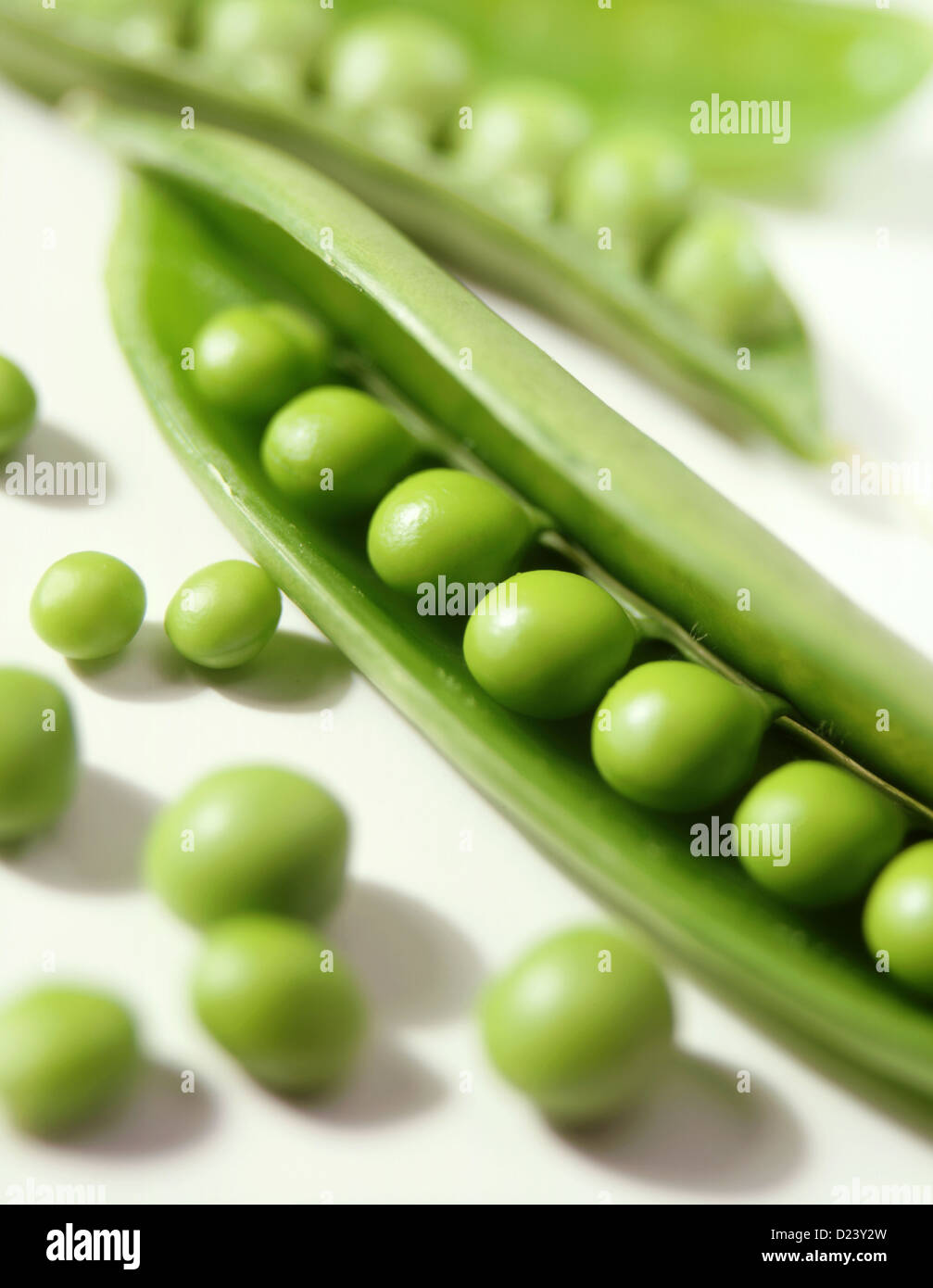 Peas in a pod on white Stock Photo