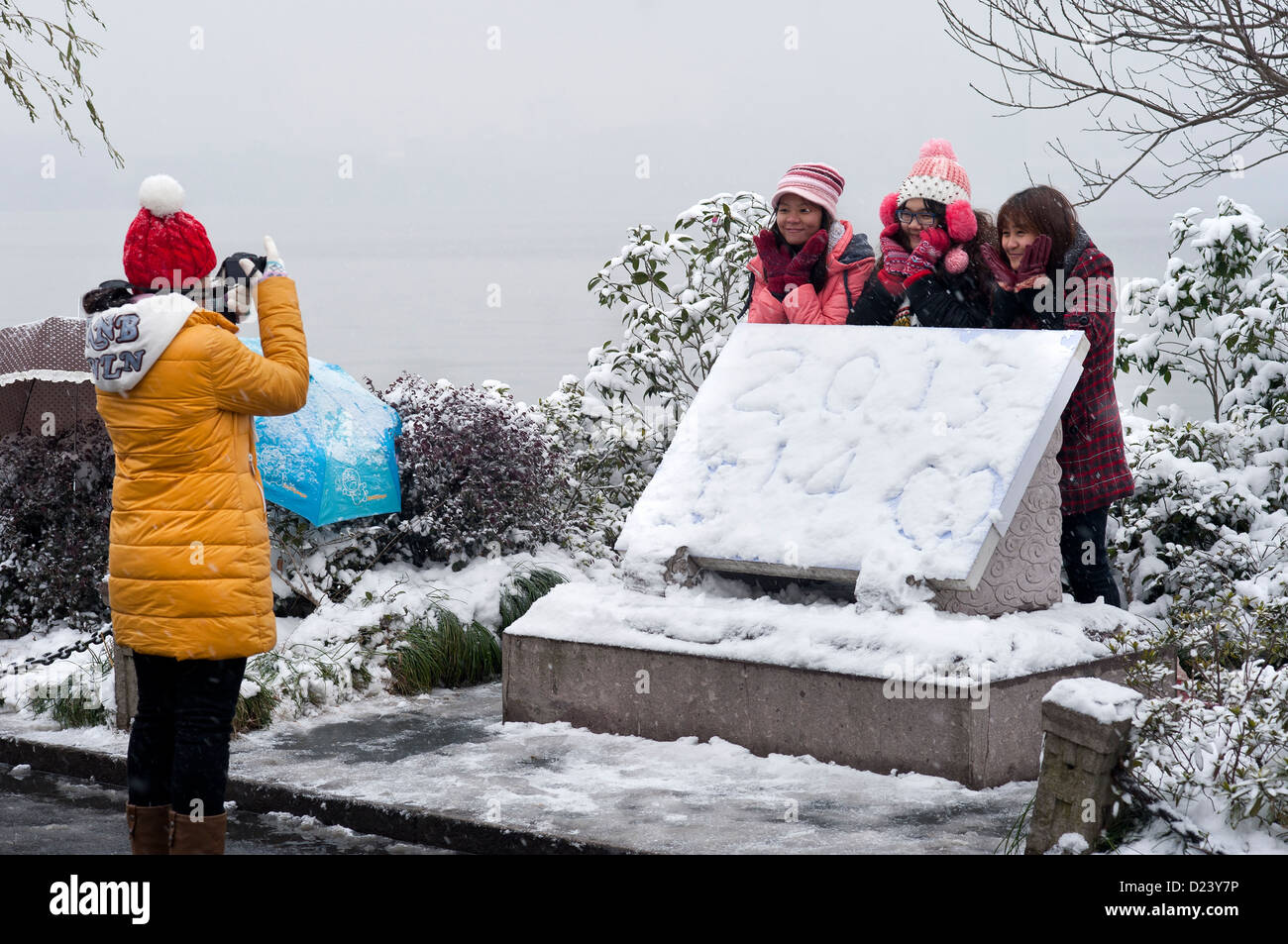 A group of Chinese girls pose for New Year photographs in the snow beside West Lake, Hangzhou Stock Photo