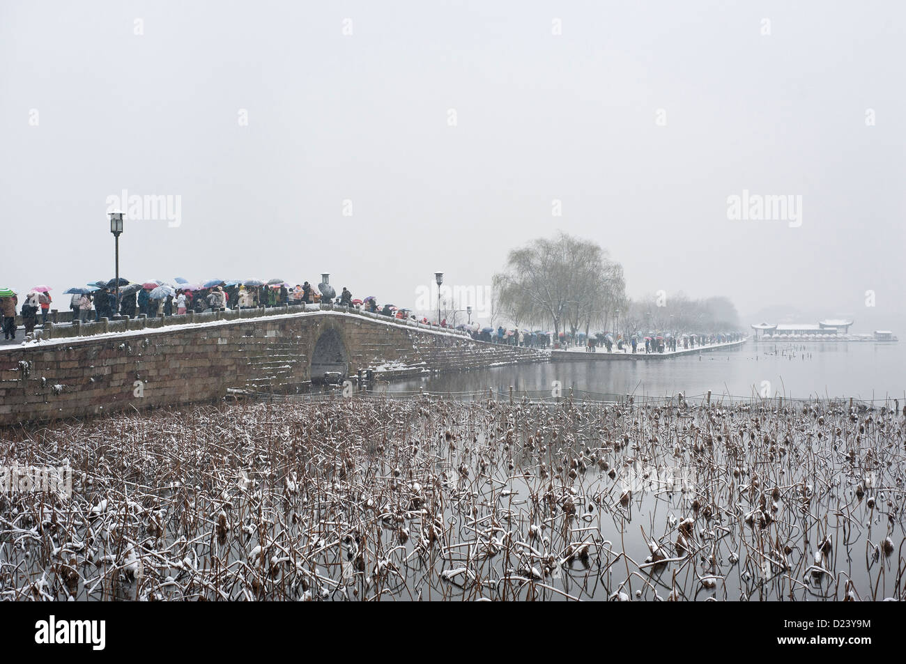 A busy Broken Bridge during winter at Hangzhou's West Lake Stock Photo
