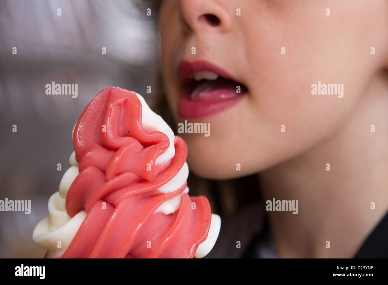 A girl about to take a bite or a lick from an ice-cream cone. Model Released. Stock Photo