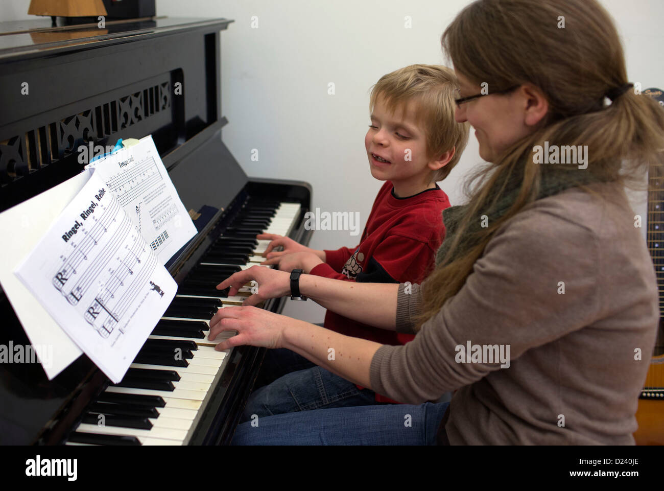 Almost blind eight year old Mario and music teacher Margarete Daiker play the piano at the State