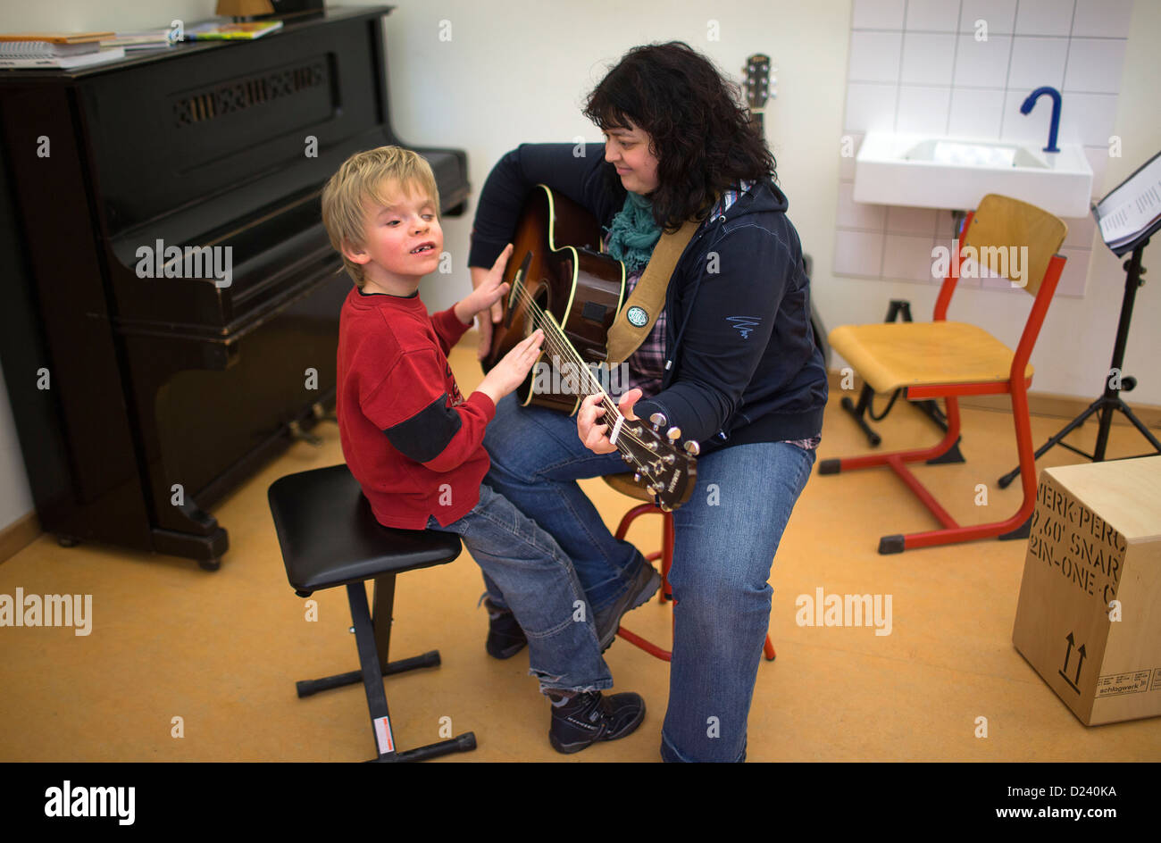 Almost blind eight year old Mario and music teacher Claudia Geist play the guitar at the State