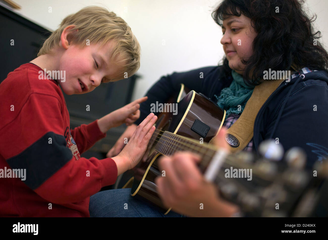 Almost blind eight year old Mario and music teacher Claudia Geist play the guitar at the State
