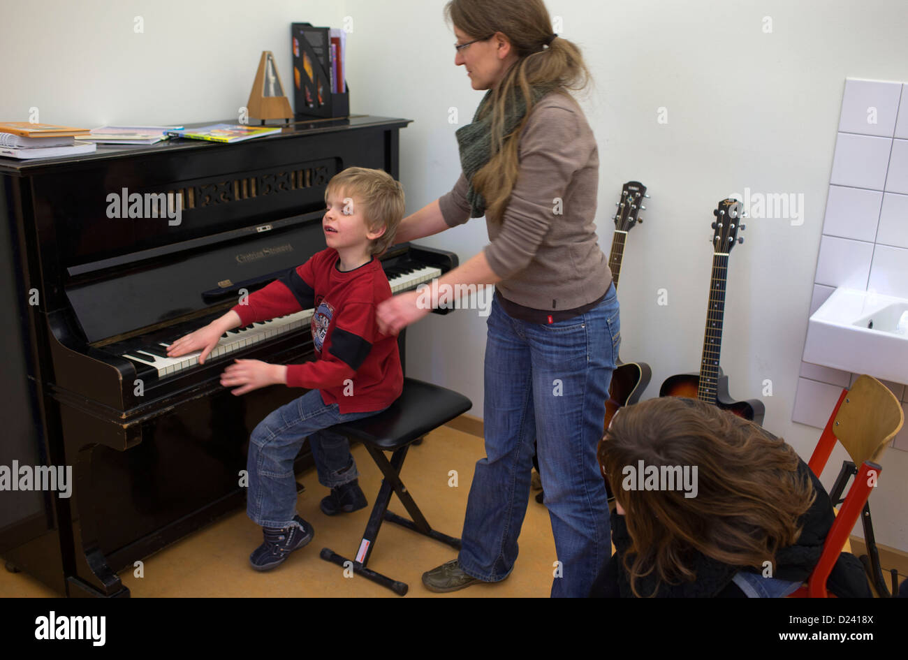 Almost blind eight year old Mario and music teacher Margarete Daiker play the piano at the State