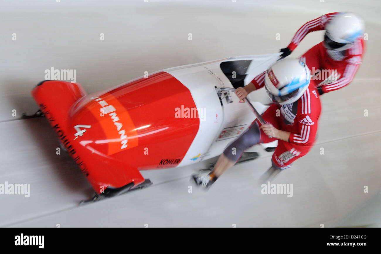 Swiss bobbers Fabienne Meyer (L) and her brakewoman Michelle Huwiler start a run at the women's two-person bobsleigh world cup at the artificial ice track at Koenigssee near Berchtesgarden, Germany, 11 January 2013. Photo: TOBIAS HASE Stock Photo