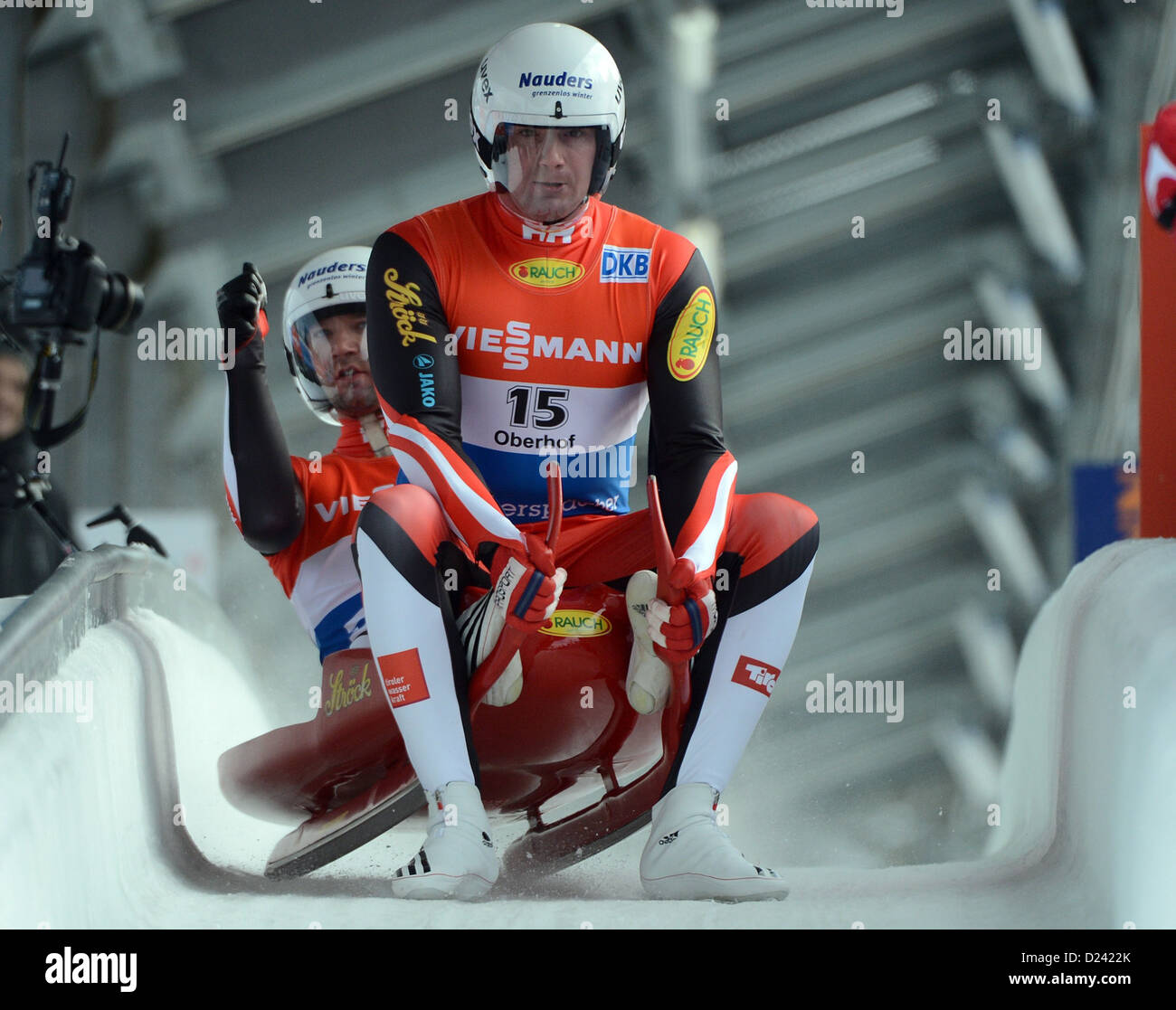 Austrian lugers Peter Penz (FRONT) and Georg Fischler celebrate after their run in the FIL European Luge Championships in Oberhof, Germany, 12 January 2013. They finished in third place. Photo: Hendrik Schmidt Stock Photo