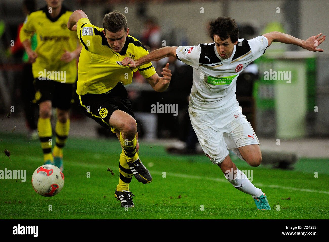 Dortmund's Lars Bender (L) and Duesseldorf's Robbie Kruse vie for the ball during the soccer Winter Cup semi final match Fortuna Duesseldorf vs Borussia Dormund at Esprit Arena in Duesseldorf, Germany, 13 January 2013. Photo: MARIUS BECKER Stock Photo