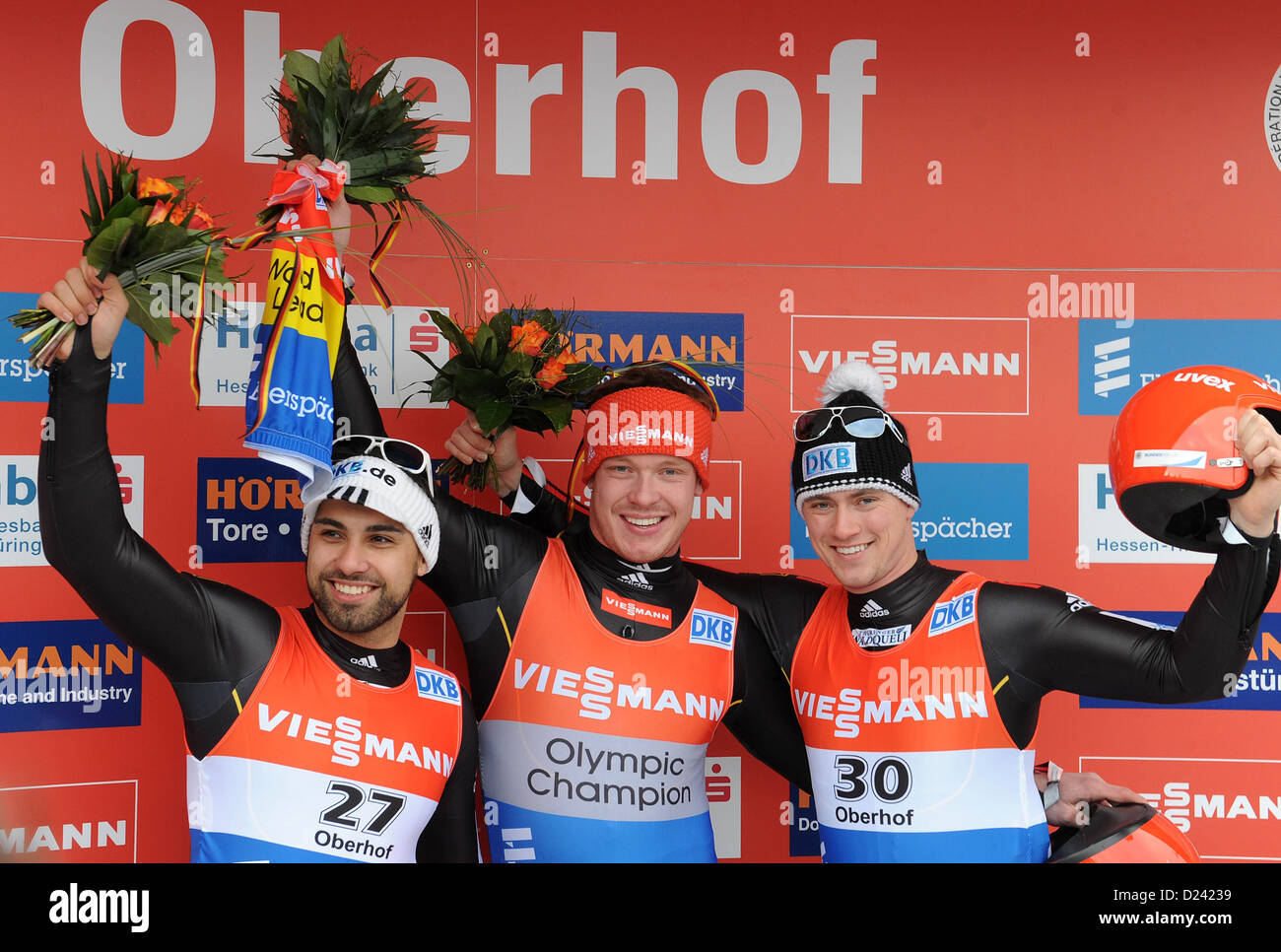 German lugers Felix Loch (C) who finished in first place, second-placed Andi Langenhahn (L) and third-placed Johannes Ludwig celebrate at the ceremony of the FIL European Luge Championships in Oberhof, Germany, 13 January 2013. Photo: Hendrik Schmidt Stock Photo