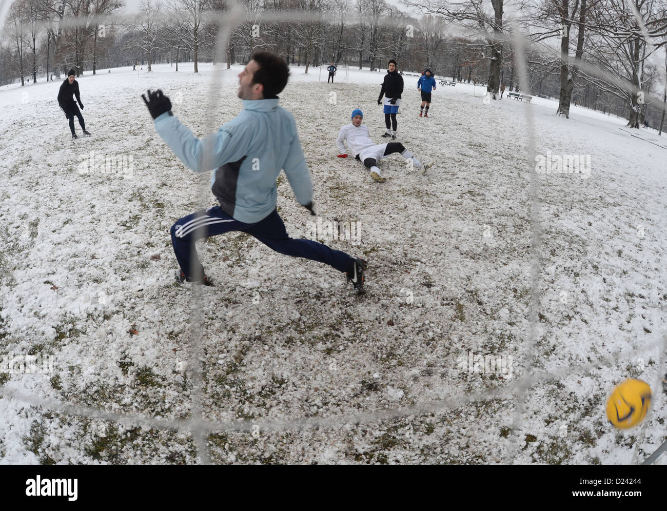 Hobby soccer players play ball on a snow-covered field in the English Garden in Munich, Germany, 12 January 2013. Photo: Felix Hoerhager Stock Photo