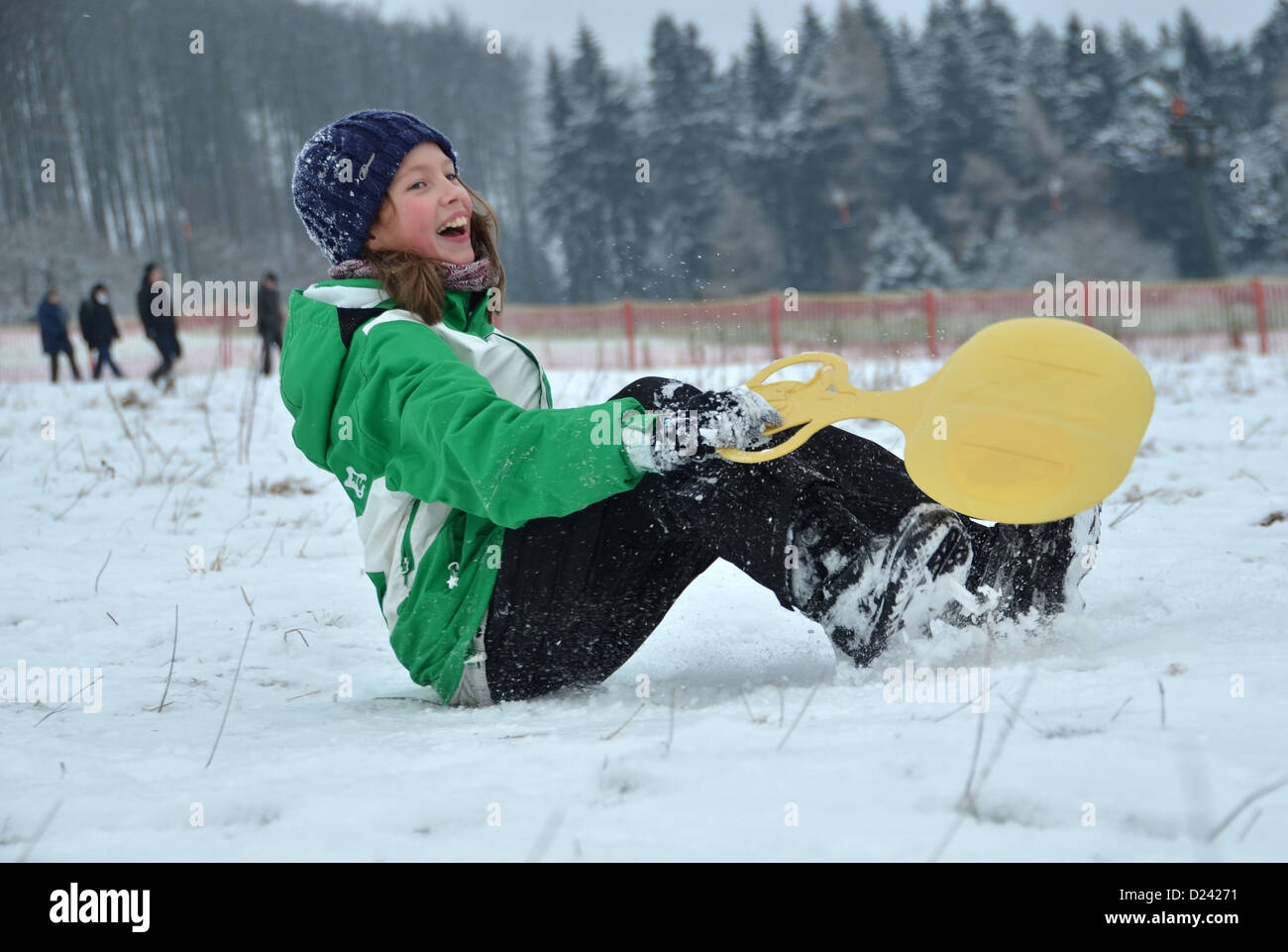 Emma lands in the snow after enjoying her sleigh ride in Habicht Forest near Kassel, Germany, 13 January 2013. Photo: Uwe Zucchi Stock Photo