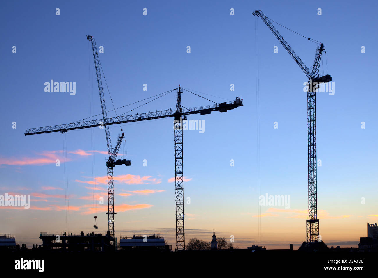 Cranes on construction work of new offices on London's Southbank, London Bridge quarter at dusk, Southwark, London, UK Stock Photo