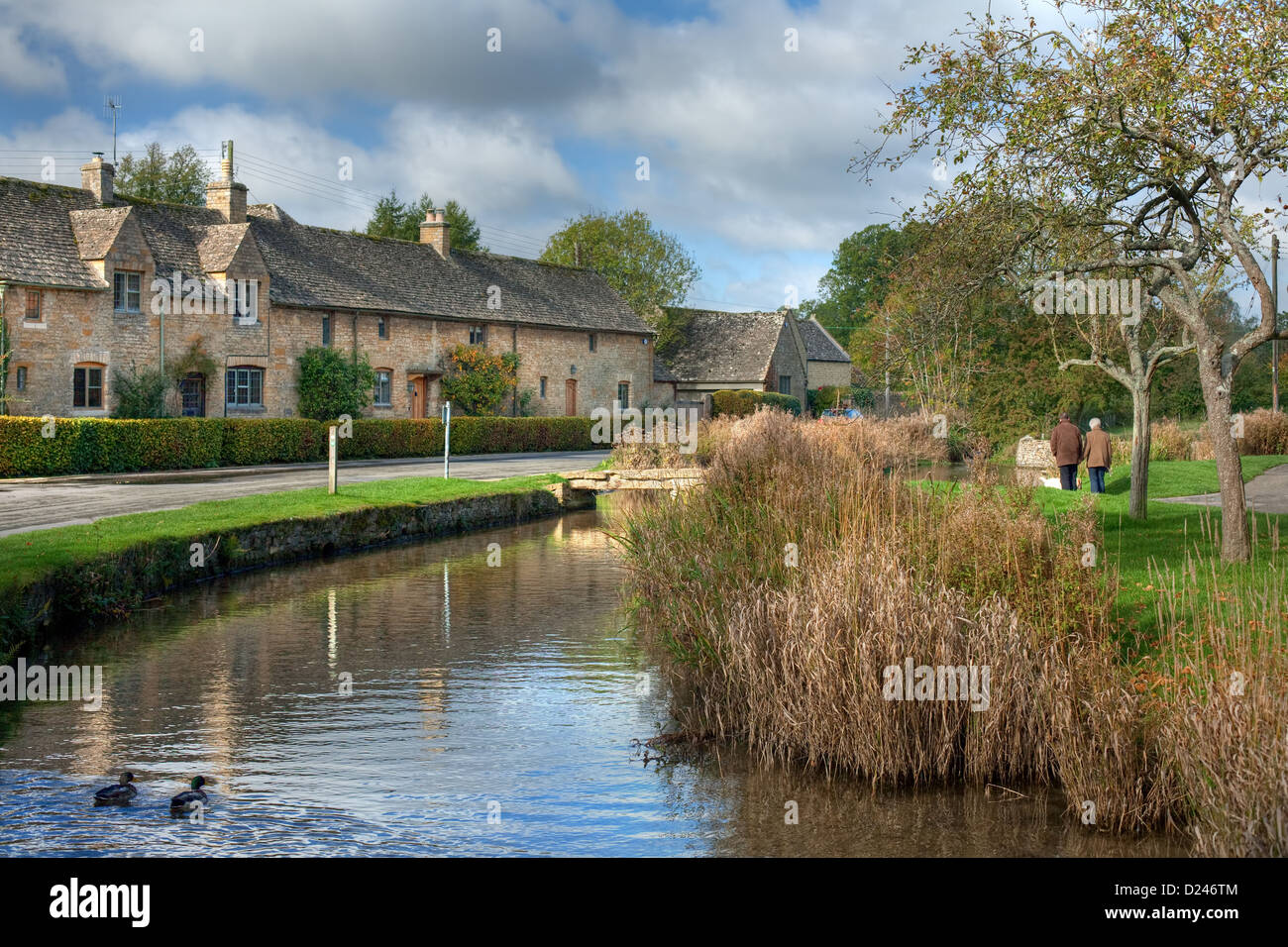 Row of Cotswold cottages on a river, England Stock Photo