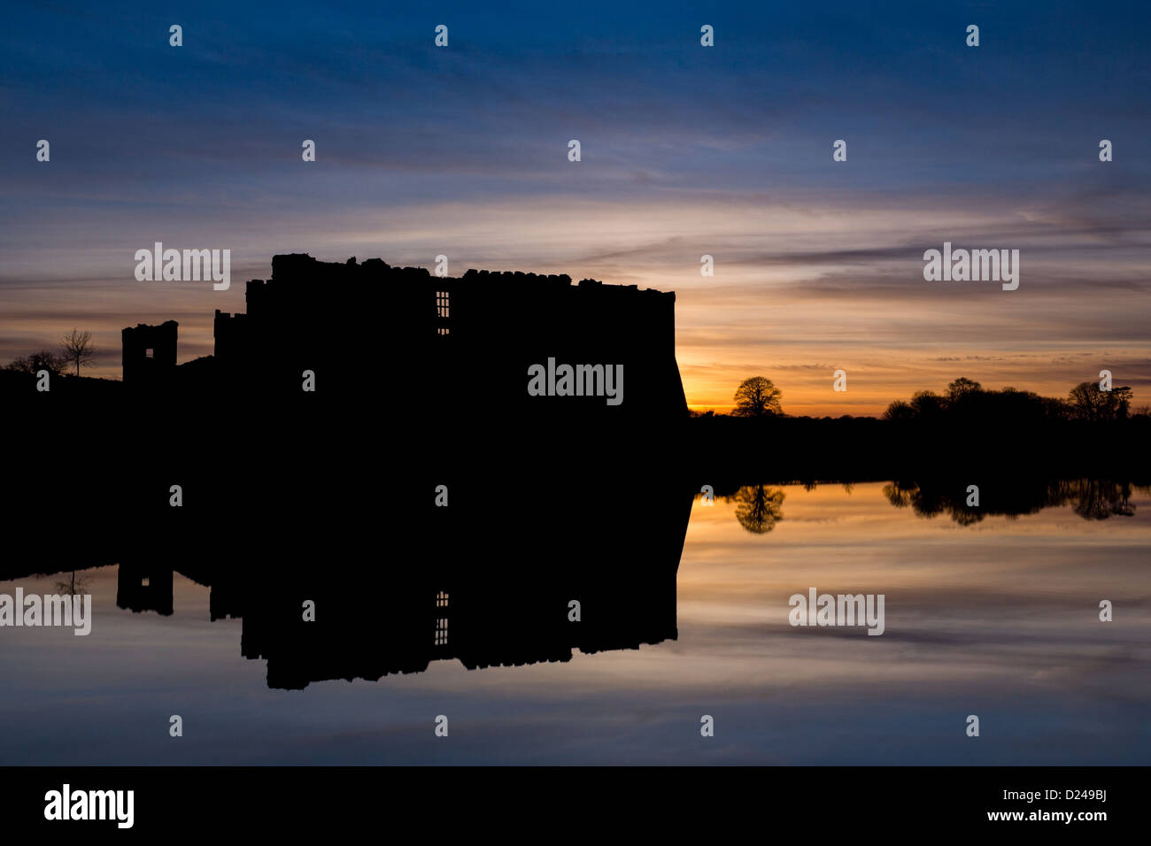 Carew Castle in Pembrokeshire, silhouette against sunset sky, in winter. Wales. Stock Photo