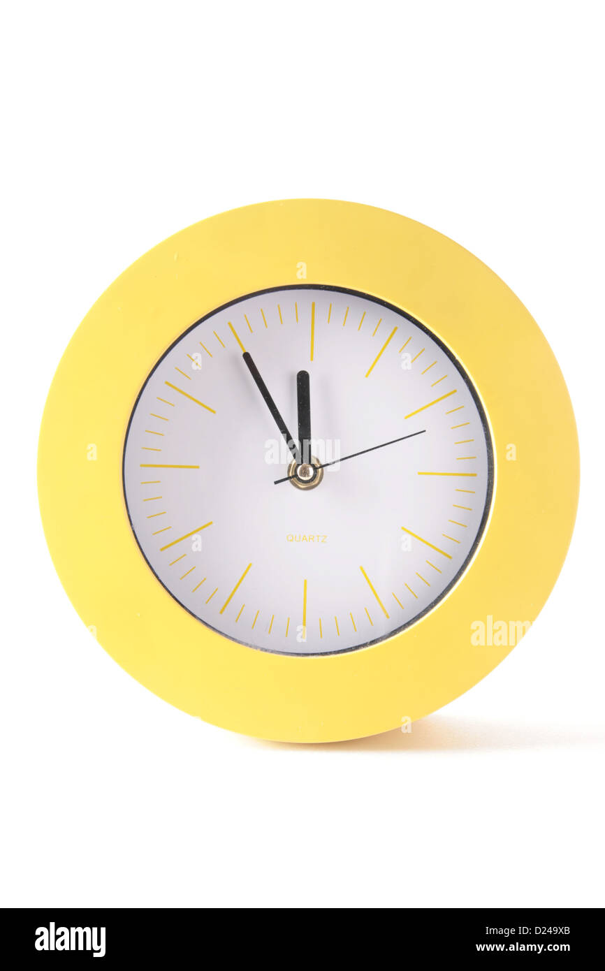 Yellow, round clock with hands on white background Stock Photo