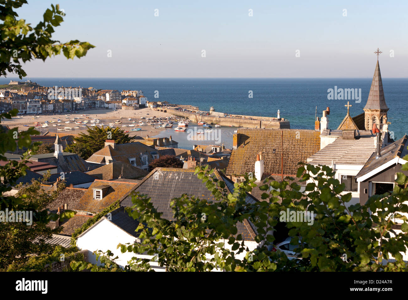 St Ives harbour and town viewed over its rooftops in evening light. Stock Photo