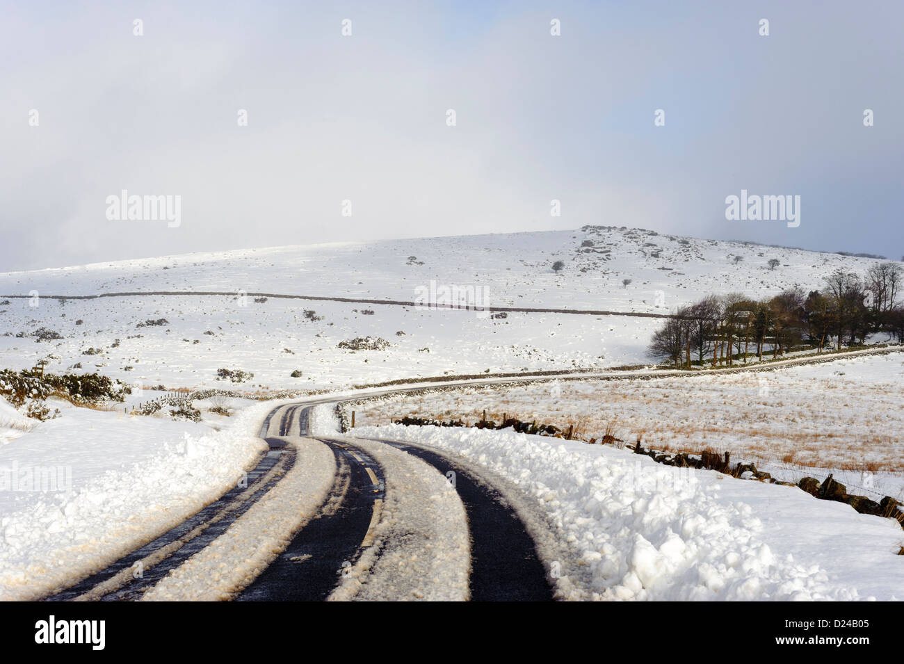 Tyre tracks through snow on the B3212 road, Dartmoor, SW England Stock