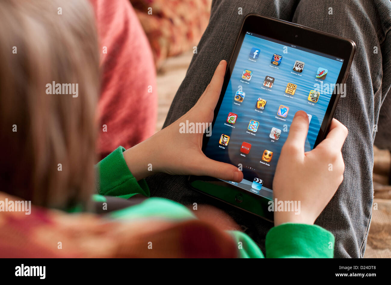 young male boy using ipad mini tablet computer Stock Photo