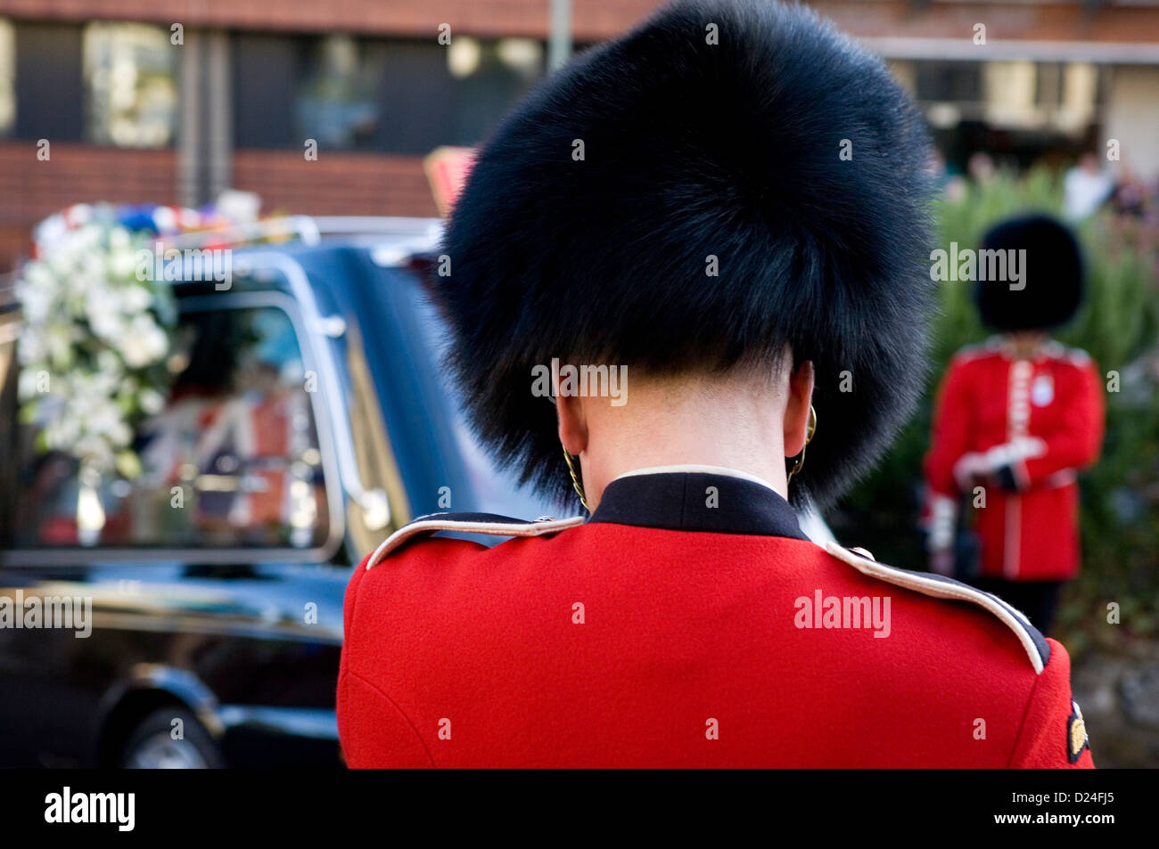 A British Guards soldier in formal dress at a military funeral in