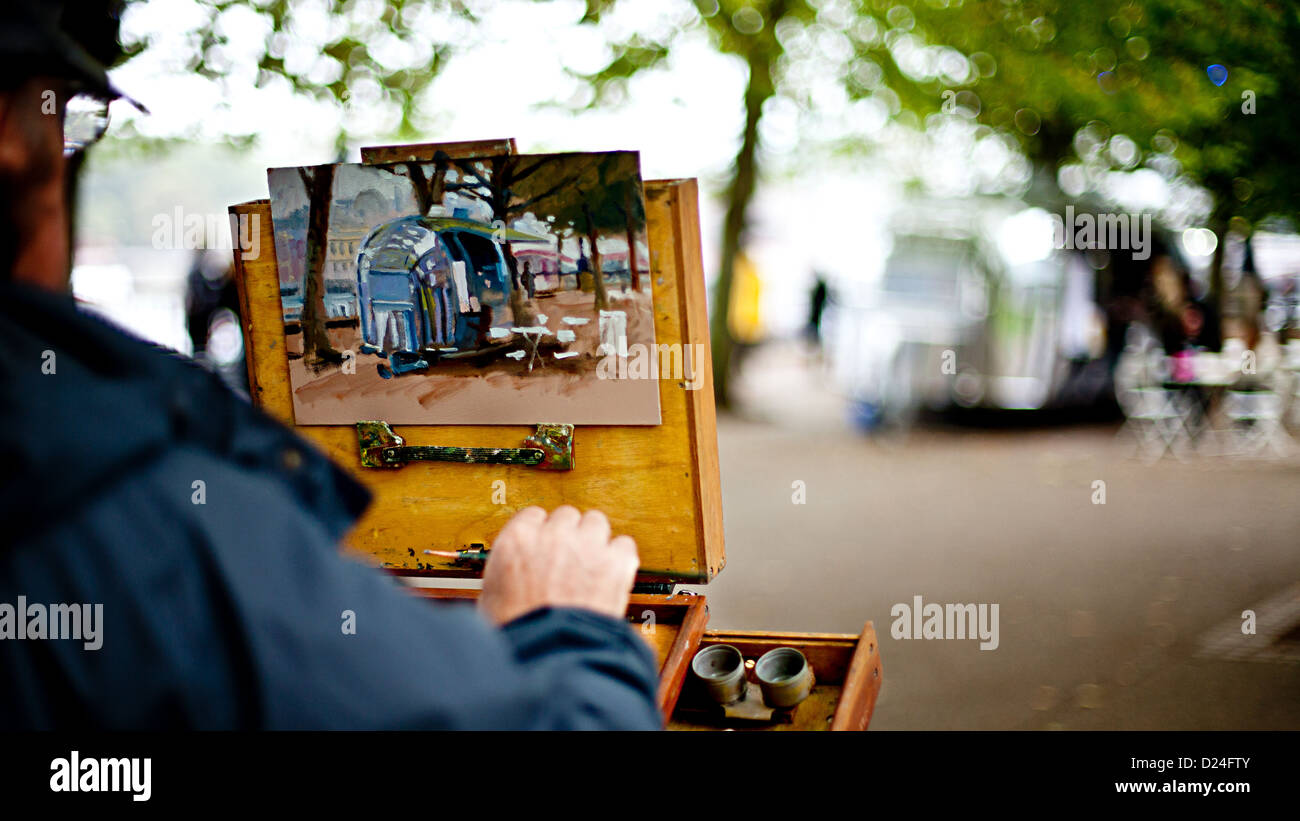 A painter painting an airstream in London Stock Photo
