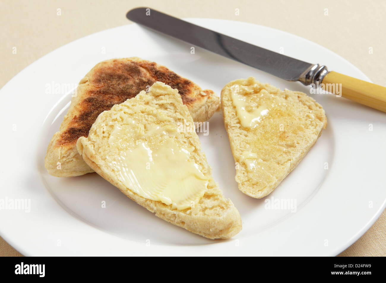 Scottish girdle (griddle) scones, one sliced and buttered, on a white