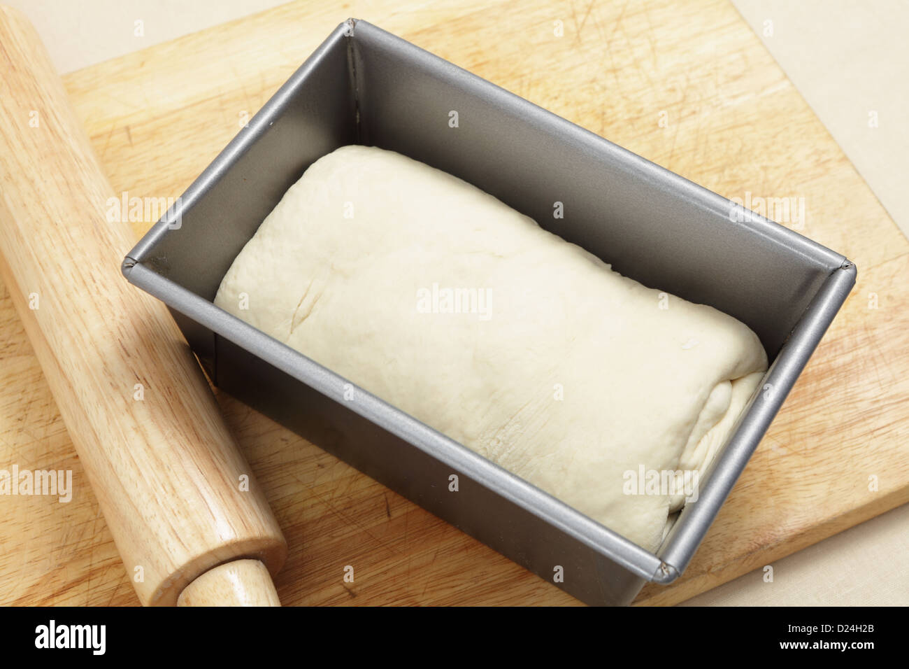 Rolled up bread dough for an English split-tin loaf, rolled up ready for its final rise. Stock Photo